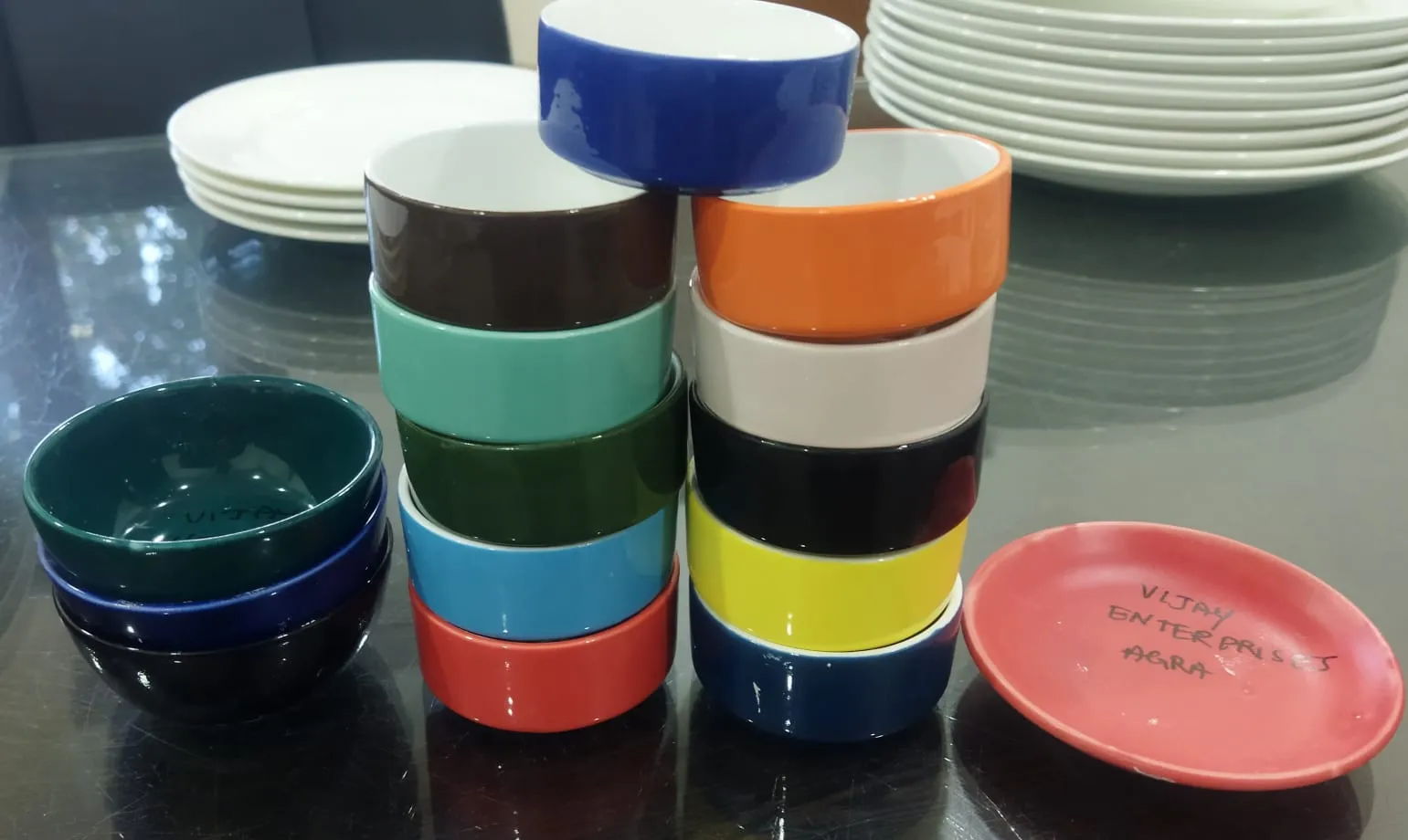 Bowls fired in blue, orange, green, yellow, black and white ceramic colours