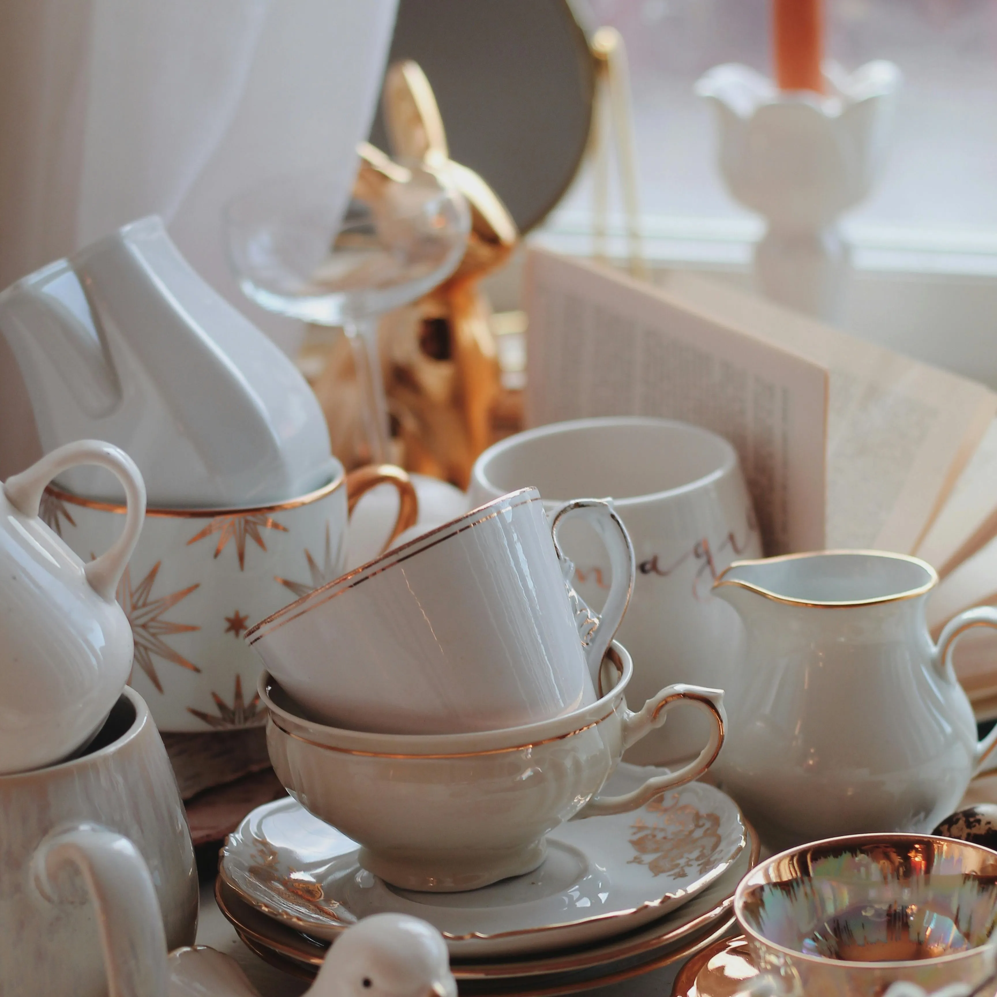 Porcelain cups and jugs finished with gold rims and pearl lustre
